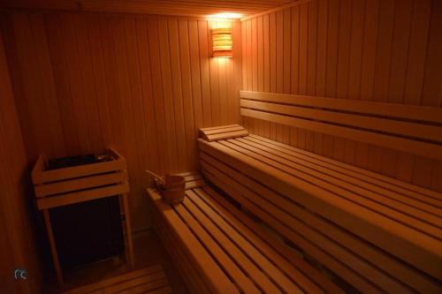 a sauna with a bench with a light on it at Zlatiborski konaci k14/3 in Zlatibor