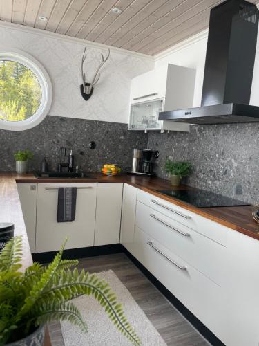 a kitchen with white cabinets and a window at Ottsjö-Åre Lodge in Ottsjö