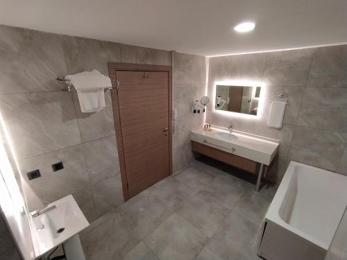 a bathroom with a sink and a toilet and a shower at Anemon Karabük Hotel in Karabük