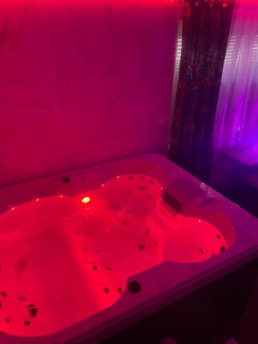 a red bath tub with a red light in it at Main de Bouddha et nonchalance in Arras