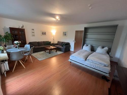 a bedroom with a bed and a living room at Luchsury Appartment in Bad Harzburg