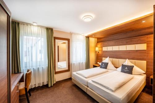 A bed or beds in a room at Aspire Castillo Reutlingen, Trademark Collection by Wyndham