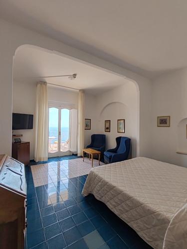 a bedroom with a bed and a view of the ocean at Grand Hotel Excelsior in Amalfi