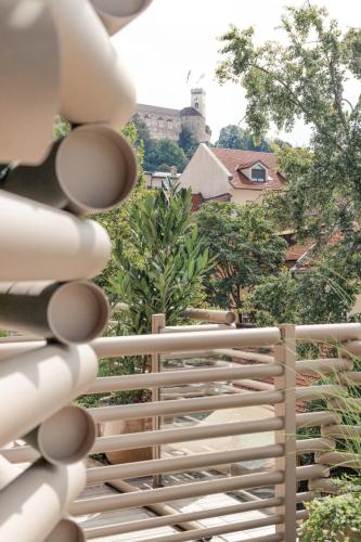 a white fence with trees in the background at AS Boutique Hotel, superior in Ljubljana