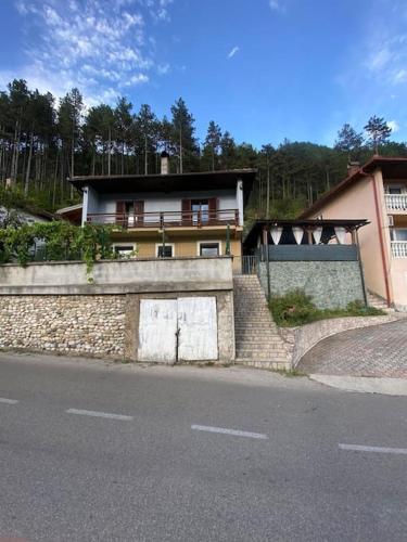 a house sitting on the side of a road at Apartman Jerkovic in Konjic