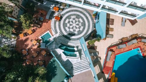 an overhead view of a swimming pool with a resort at Santa Marina Unique Hotel in Agios Nikolaos