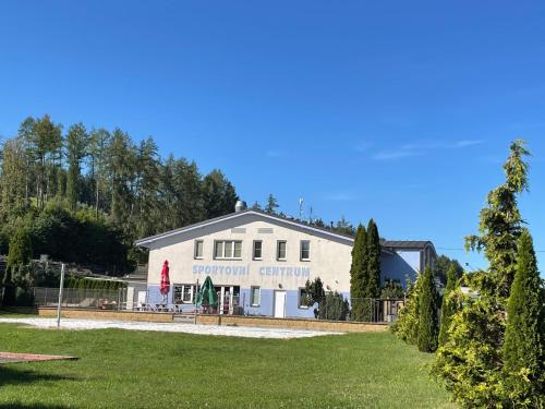 a white building with a sign on it at Vila Máchovka in Nová Paka