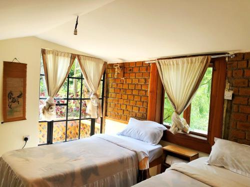 sypialnia z 2 łóżkami i oknem w obiekcie The Murana Chalet w mieście Nanyuki