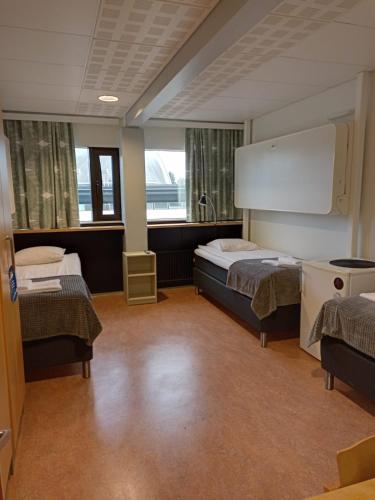 Un ou plusieurs lits dans un hébergement de l'établissement Hotel Tikkurila