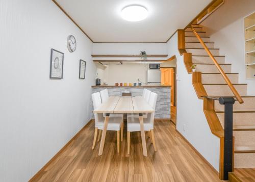 a kitchen and dining room with a table and chairs at HANASTAY花渓居 野田Noda in Osaka