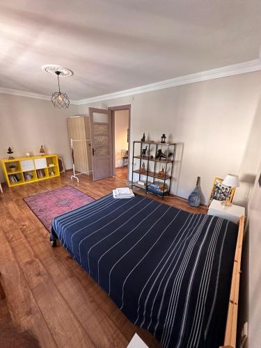 a bedroom with a large blue bed in a room at Historic Wooden House with Bosphorus view in Sarıyer