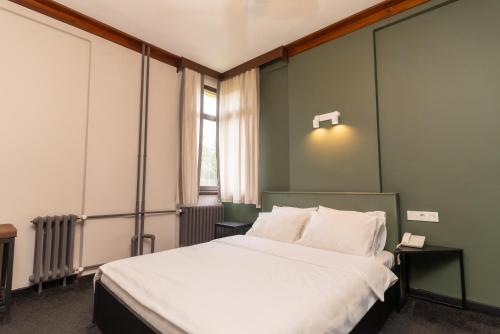 a bedroom with a large bed and a window at Iliada Hotel Kaz Daglari in Kalkım