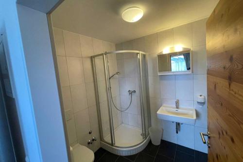 a bathroom with a shower and a toilet and a sink at Wohnung Kirchdach 145 - Naviser Huette in Navis