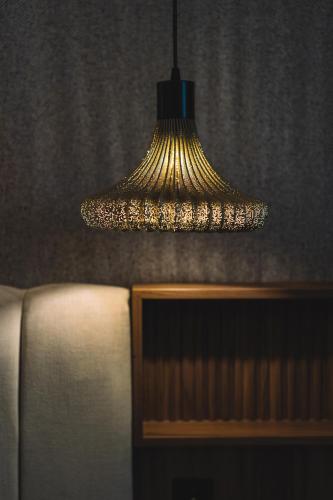 a lamp hanging over a couch in a room at Hotel Pinar Plaza in Madrid