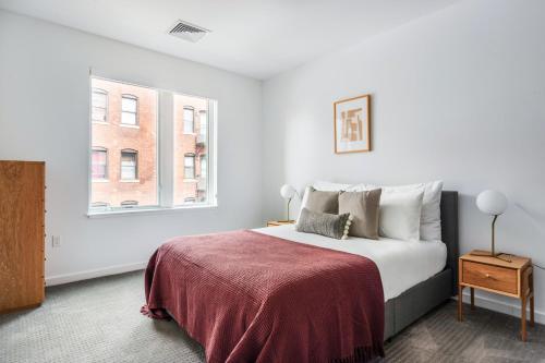 a white bedroom with a bed and a window at Central Sq 3BR w WD nr MIT Kendall Sq BOS-367 in Cambridge