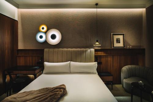 a bedroom with a bed with eyeballs on the wall at Hotel Pinar Plaza in Madrid