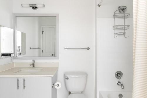a white bathroom with a toilet and a sink at U Street 1br w gym nr metro nightlife WDC-710 in Washington