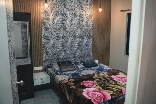 a bedroom with a bed with flowers on it at Tulip Villa in Mulshi