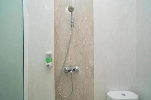 a shower in a bathroom with a toilet at Behomy 3C Residence near ICE BSD in Tangerang