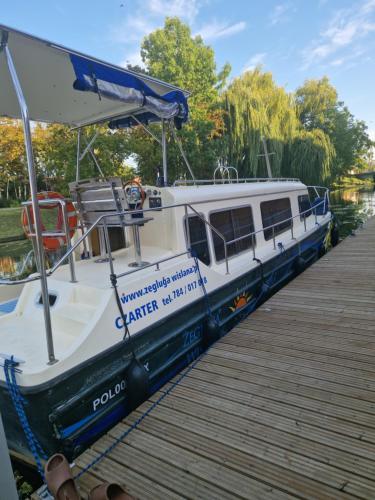 a boat is docked at a dock at Nowodworski in Nowy Dwór Gdański