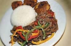 a white plate of food with rice and meat at Hotel Cubamia in Romano D'Ezzelino