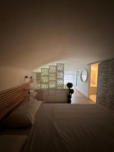 a bedroom with a large bed and a brick wall at [Verdesera] Idromassaggio, Netflix, Wifi a Porta Susa in Turin