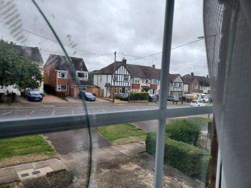 a view from a window of a street with houses at Poynters House - Huku Kwetu Luton & Dunstable - Spacious 2 Bedroom House-Private garden and parking in Luton