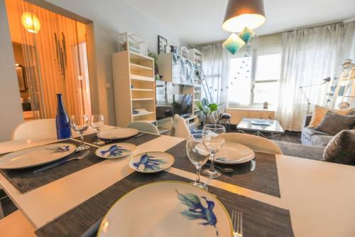 a dining room table with plates and wine glasses at Le Rhône in Annecy