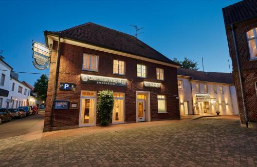 a brick building on a city street at night at Hotel & Gasthaus Nagel GmbH in Südlohn