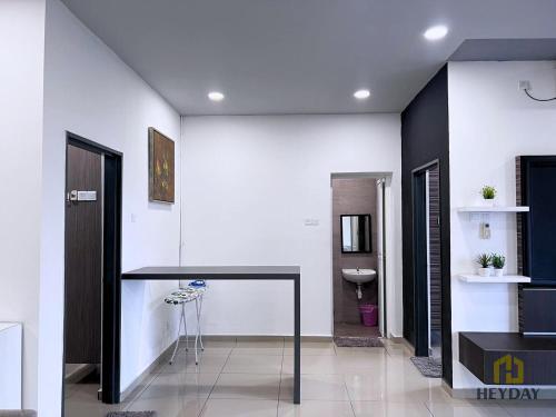 a bathroom with a black counter and a sink at Seaview Homestay Masai by Heyday in Masai