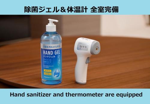 a bottle of hand sanitizer and thermometer are equipped at Laffitte Hirai Condominium Hotel in Tokyo