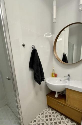 a bathroom with a sink and a mirror at Fantastic - KP69 Room D in Warsaw