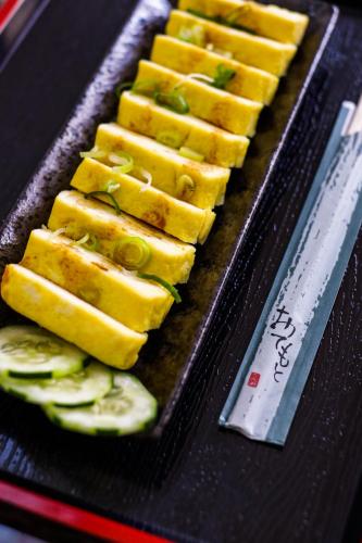 a plate of food with sliced cucumbers on it at MinshukuKCS Hotel and Restaurant in Puerto Galera