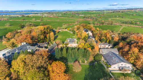 an aerial view of a house in a field with trees at Thurnham Hall Resort in Cockerham