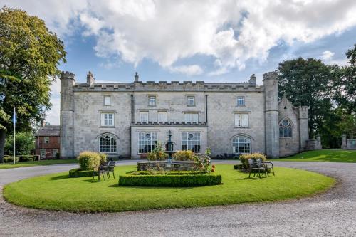 an old castle with a garden in front of it at Thurnham Hall Resort in Cockerham