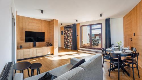 a living room with a couch and a table at Foka, Sun & Snow in Hel