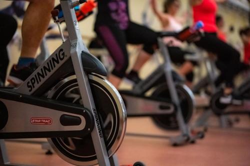 a group of people on exercise bikes in a gym at Eleven Business & Sport Hotel in Jászárokszállás