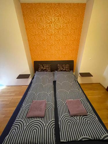 a bed with two pillows in a room at IK Apartment in Debrecen