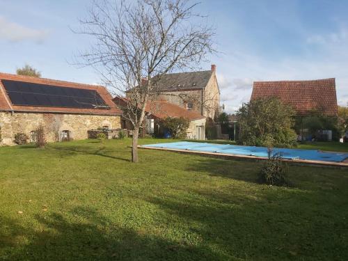 a house with a yard with a swimming pool at les glycines in Saint-Marien