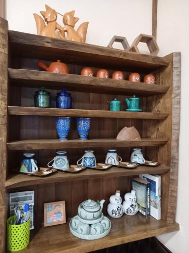 a shelf filled with blue and white ceramics at Hakuba Powder Lodge Taketombo in Hakuba