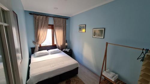 a bedroom with a bed in a blue room at Condo Reina, Kusadasi in Kuşadası