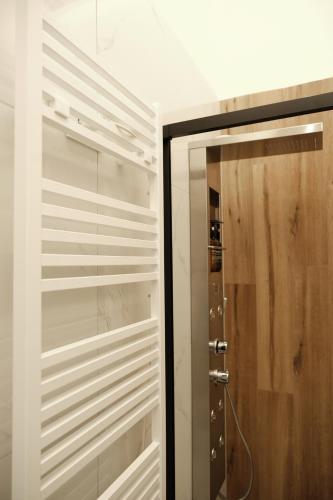 a closet with a glass door and a shower at Doryana Luxury in Naples