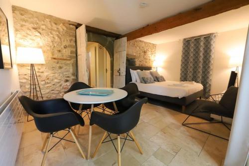 um quarto de hotel com uma cama, uma mesa e cadeiras em Pierres plates em Annecy