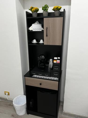 a black coffee machine in a corner of a room at B&B il Rio in Anacapri