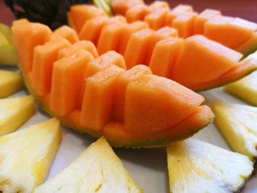 a close up of slices of cantaloupe and pineapple at Panorama Suite in Piazza Armerina