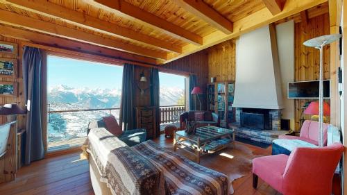 a living room with a view of a mountain at Tschoueilles 5 MOUNTAIN & QUIET chalet 10 pers in Veysonnaz