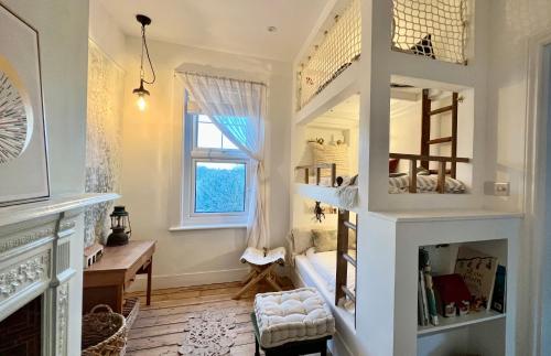 a childs room with a bunk bed and a window at Rosa - Joss Bay in Kent