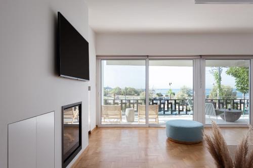 a living room with a fireplace and a tv at Glyfada Unique Residence in Athens