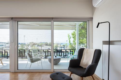 a living room with sliding glass doors at Glyfada Unique Residence in Athens