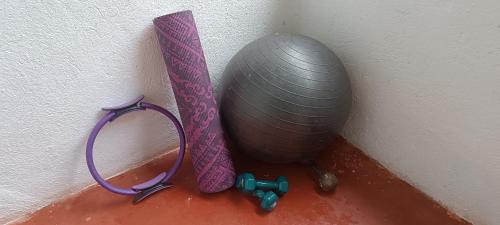 a exercise ball and a purple ribbon next to a wall at Casa Margarita in Santa Marta